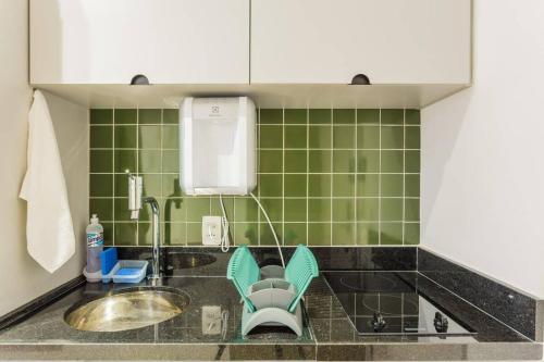 a kitchen with a sink and green tiles at BHomy República Moderno e desejado SE1305 in São Paulo