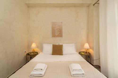 a bedroom with a large bed with towels on it at Maisonette Pylos in Pylos