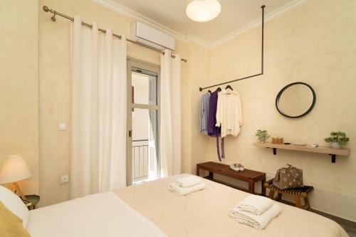 a bedroom with a bed with a mirror and a window at Maisonette Pylos in Pylos