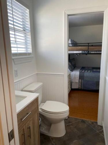a bathroom with a toilet and a bunk bed at Updated,spacious, maritime 3BR downtown cottage in St. Augustine