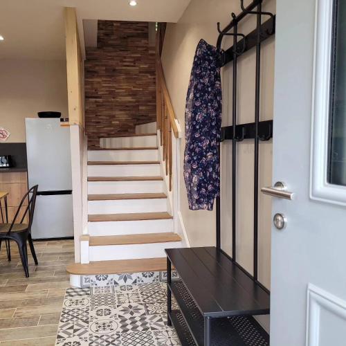 a staircase in a room with a table and a door at La Buguoise in Le Bugue