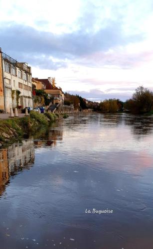 a river with buildings on the side of it at La Buguoise in Le Bugue