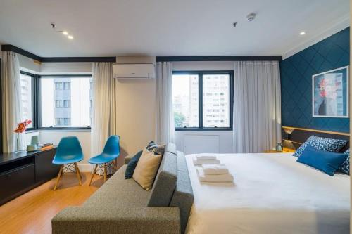 1 dormitorio con 1 cama grande y 1 sofá en BHomy Jardins Charme no melhor do bairro CE505, en São Paulo