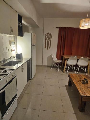 a kitchen and dining room with a table and a kitchen and a tableablish at Palermo Apart 3 in Buenos Aires