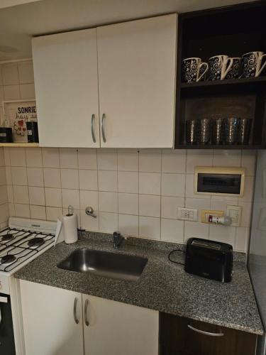 a kitchen with a sink and a counter top at Palermo Apart 3 in Buenos Aires