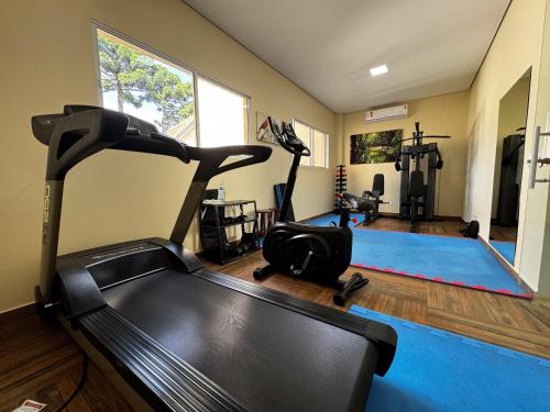 a room with a gym with a treadmill at Pousada Kaliman Luxo in Campos do Jordão