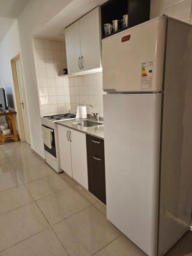 a kitchen with a refrigerator and a sink at Palermo Apart 3 in Buenos Aires