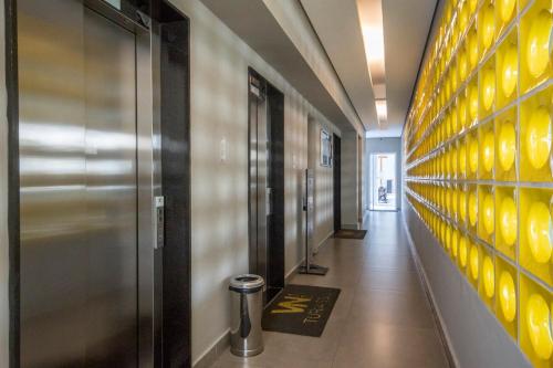 a hallway with a row of elevators in a building at BHomy Turiassu in Sao Paulo