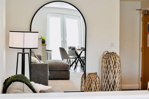 a living room with a mirror and a couch at *Luxury Apartment 2min from City in Carlisle