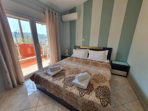 a bedroom with a bed with two pillows on it at Callistemon Loft Apartment in Potos