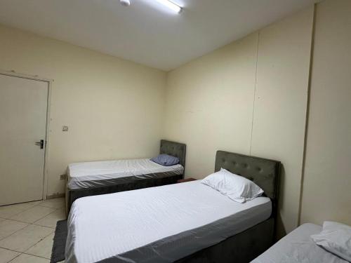 a room with two beds in it with at MIRA ALMAJAZ in Sharjah