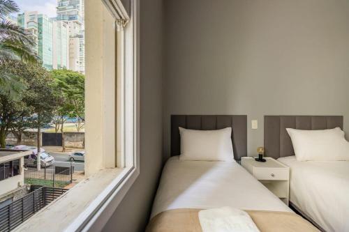 2 camas en una habitación con ventana en BHomy Rua Antônio Carlos 196, en São Paulo
