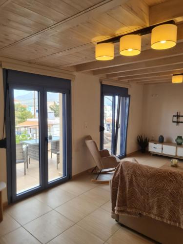 a bedroom with a bed and sliding glass doors at Maria’s family house’s in Elafonisos