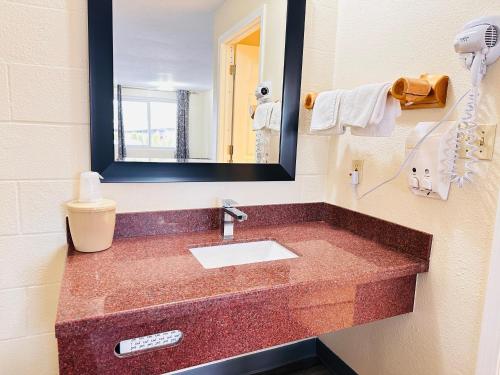 a bathroom with a sink and a mirror at Northwoods Motel in Blaine