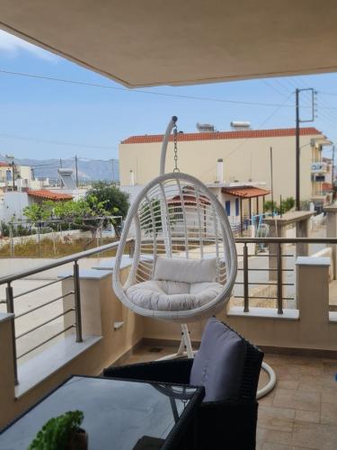 a white swing sitting on top of a balcony at Maria’s family house’s in Elafonisos