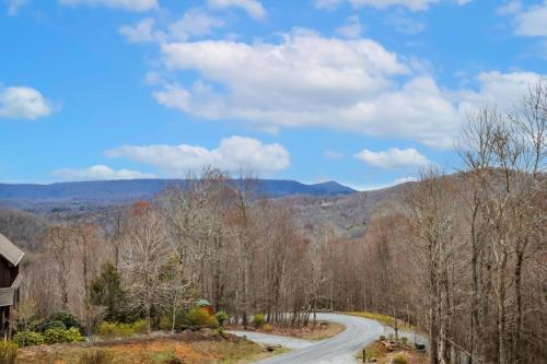 a road in the mountains with trees and a house at Mountain View Manor in Banner Elk