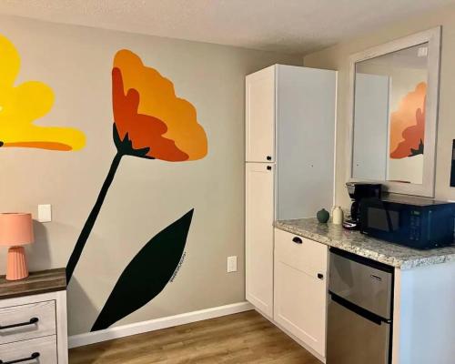 a kitchen with a flower mural on the wall at Wildflower Room At The Trailblazer Unit 10 in Townsend