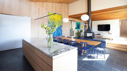 a kitchen and dining room with a table and chairs at Portsea Shingle House in Portsea
