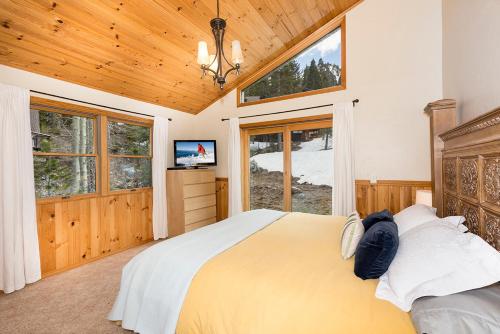 a bedroom with a large bed and a large window at Mineral Springs 3 BR w Hot tub Available in Alpine Meadows in Olympic Valley