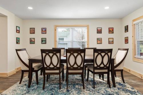 a dining room with a table and chairs at Pondview 4BR Cabin-Walk to Caverns, Hot Tub, Wi-Fi in Luray