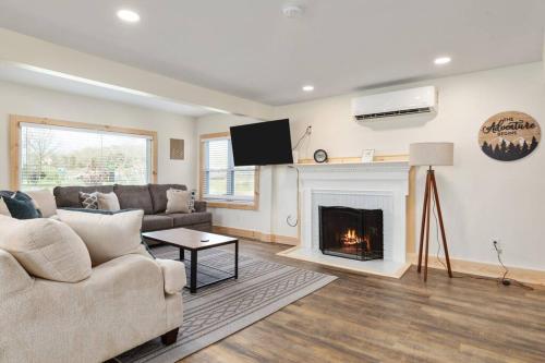 a living room with a couch and a fireplace at Pondview 4BR Cabin-Walk to Caverns, Hot Tub, Wi-Fi in Luray