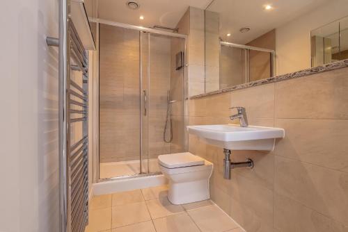 a bathroom with a shower and a toilet and a sink at Luxury 2BR Overlooking Portland Gardens in Bristol