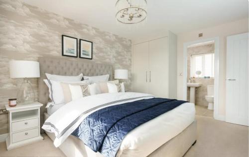 a bedroom with a blue and white bed and a bathroom at Stunning stylish 3bed house in Reading city centre in Reading