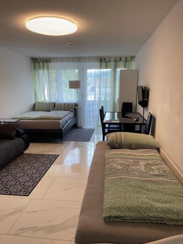 a living room with two beds and a couch at City Apartment in Bad Säckingen