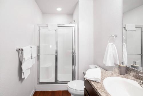 a bathroom with a shower and a toilet and a sink at Private 2Bdrm Apartment Convenient to All in Greeley