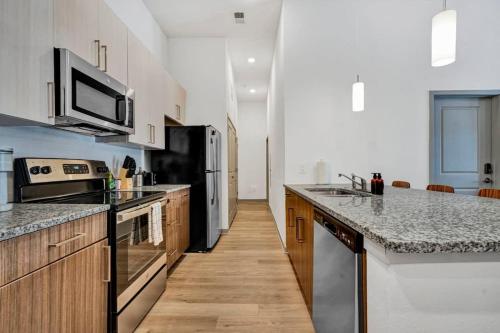 a kitchen with stainless steel appliances and wooden cabinets at Dockside on Lake Hartwell near Death Valley in Clemson