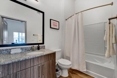 a bathroom with a toilet and a sink and a shower at Dockside on Lake Hartwell near Death Valley in Clemson