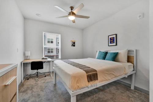 a bedroom with a bed with a desk and a ceiling fan at 1 mi to DT and near Death Valley great amenities in Clemson