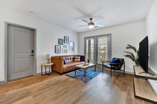 a living room with a couch and a tv at Near CU and minutes to DT gym pool hammock in Clemson