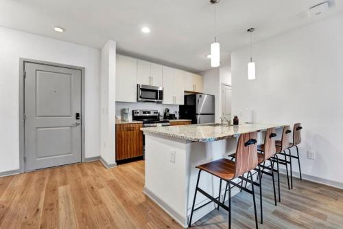 an empty kitchen with a counter and chairs in it at Near CU and minutes to DT gym pool hammock in Clemson