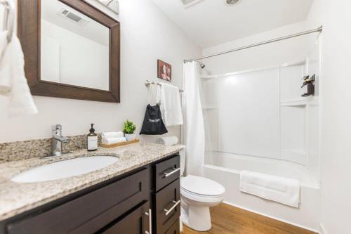 a bathroom with a sink and a toilet and a shower at The Lofts at Cherry DT w Amenities in Macon