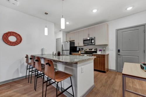 a kitchen with white cabinets and a island with bar stools at Dockside Lake Hartwell 2BR with Unique Amenities in Clemson