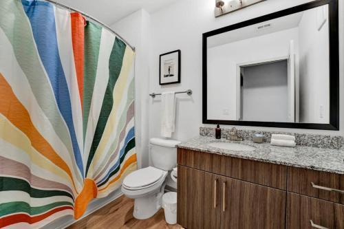 a bathroom with a toilet and a sink and a mirror at Dockside Lake Hartwell 2BR with Unique Amenities in Clemson