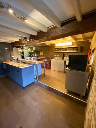 a large kitchen with a blue island in a room at MAS DE JOUAS Remy in Saint-Rémy