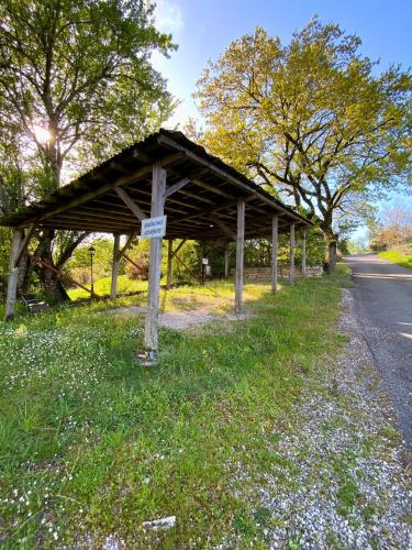 a wooden pavilion on the side of a road at MAS DE JOUAS Remy in Saint-Rémy