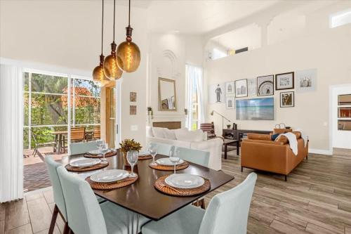 a dining room and living room with a table and chairs at Luxury 4BR Home at Ventura Golf and Country Club in Orlando