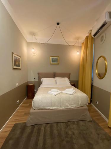 a bedroom with a bed with two towels on it at Esposizione Roof in Rome