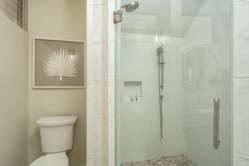 a bathroom with a glass shower with a toilet at B-204 Haleakala Shores in Wailea