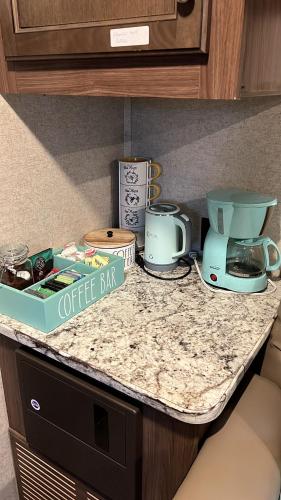 a counter top with a coffee maker and a box on it at Garden Paradise RV Camper near Clearwater Beaches in Largo