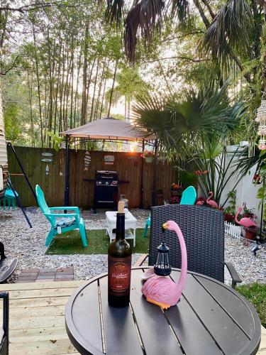 a bottle of wine and a pink flamingo on a table at Garden Paradise RV Camper near Clearwater Beaches in Largo