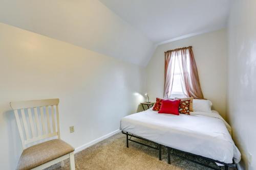 a small bedroom with a bed and a chair at Cozy East Pittsburgh Home - 7 Mi to Frick Park! in East Pittsburgh