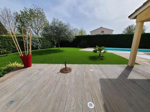 Elle offre une vue sur une arrière-cour dotée d'une terrasse en bois. dans l'établissement Belle maison, à Bruguières