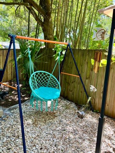 a blue swing in front of a fence at Garden Paradise RV Camper near Clearwater Beaches in Largo