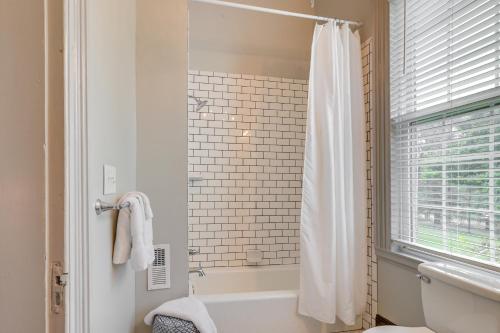 ein Badezimmer mit einem weißen Duschvorhang und einer Badewanne in der Unterkunft Milledgeville Home with Fire Pit and Pond Access! in Milledgeville