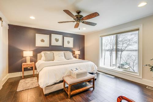 a bedroom with a bed and a ceiling fan at Lakefront Lake Oconee Home Boat Dock and Hot Tub in Eatonton 