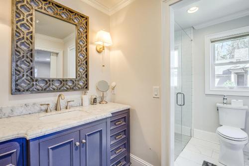 a bathroom with a sink and a toilet and a mirror at Lakefront Lake Oconee Home Boat Dock and Hot Tub in Eatonton 